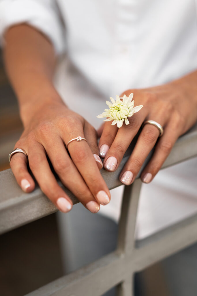 woman showing her nail art fingernails with flower